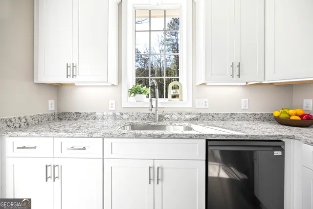 a spacious bedroom with two beds a chandelier and a window