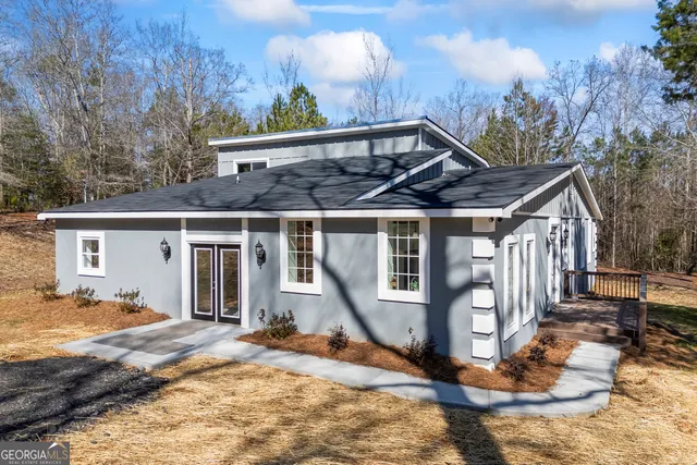 a view of a house with backyard space and wooden deck