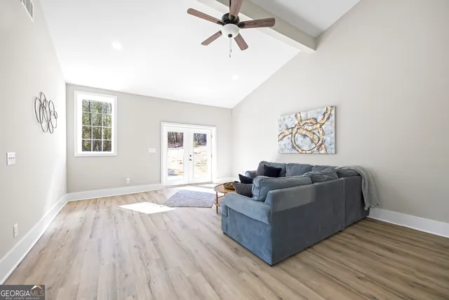 a view of a small space with wooden floor and a window