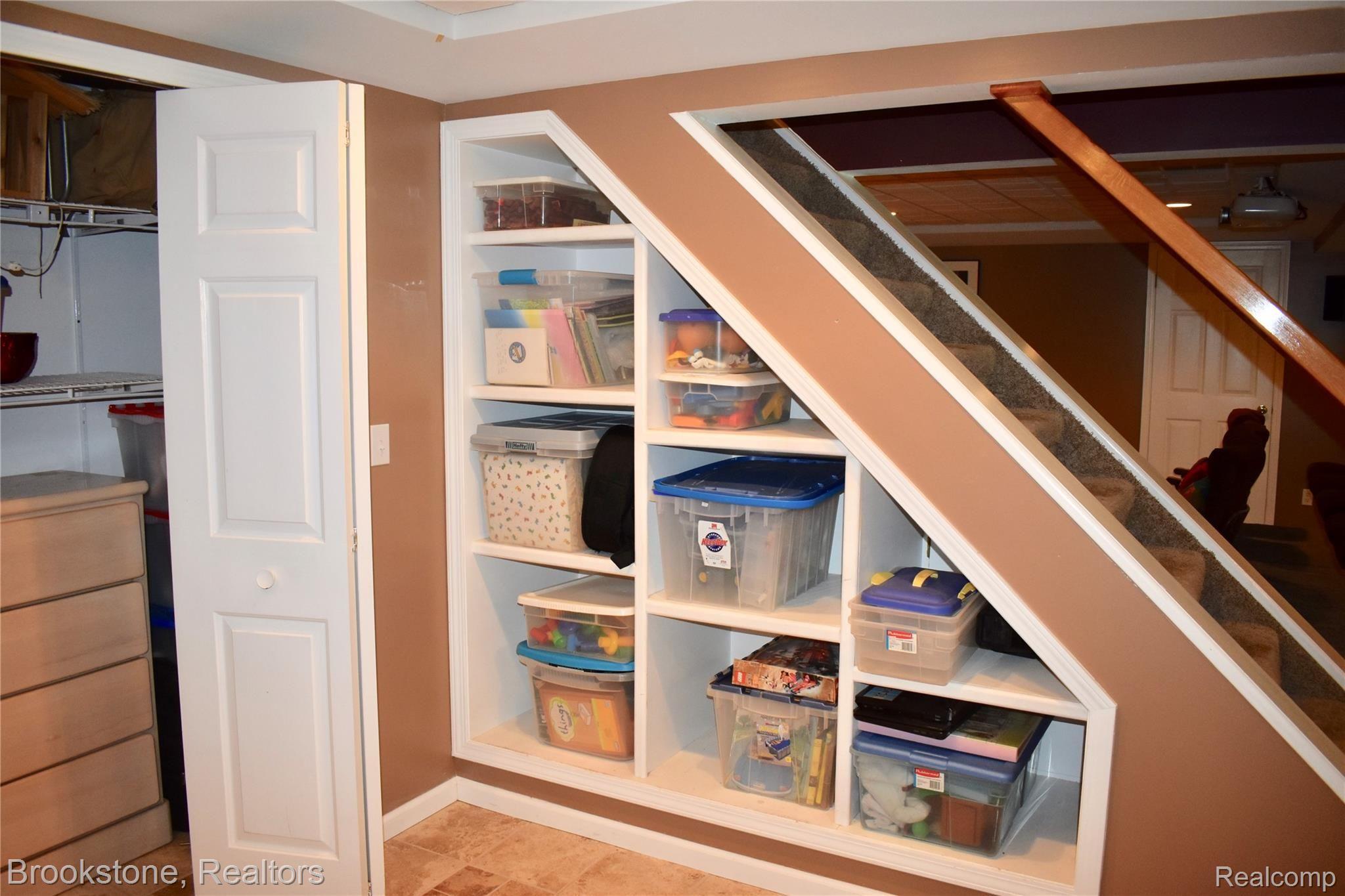 405 Baldwin Ridge Oxford, MI 48371 - Photo 50 of 54 THE OWNER HAD DESIGNS TO CONVERT THE CHILDREN'S STORAGE AREA WHICH IS LOCATED NEXT TO THE BASEMENT STAIRS INTO A WINE CELLER AS THE COOL BASEMENT WALLS CREATE A PERFECT ENVIRONMENT FOR A WINE CELLER.