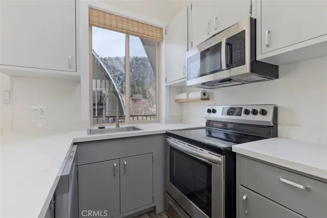 a kitchen with a refrigerator stove and microwave