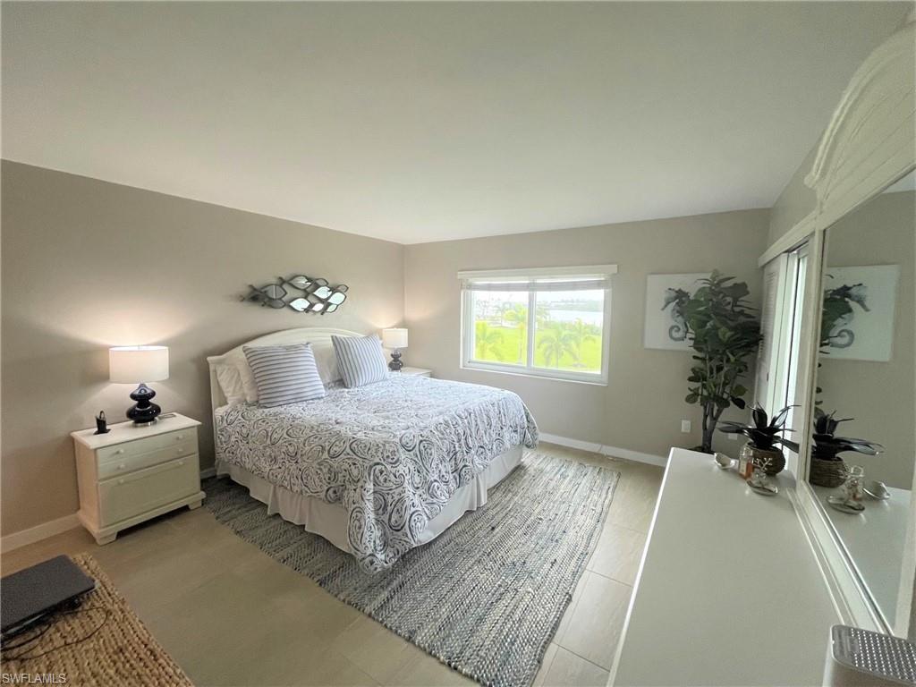 309 Goodlette-Frank Road, Unit 306A Naples, FL 34102 - Photo 11 of 19 a bedroom with a bed and a couch