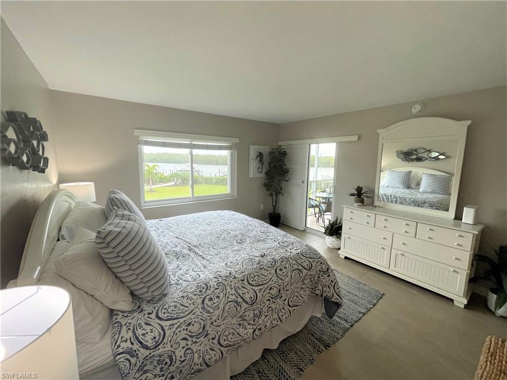 309 Goodlette-Frank Road, Unit 306A Naples, FL 34102 - Photo 12 of 19 a bedroom with a bed and a dresser