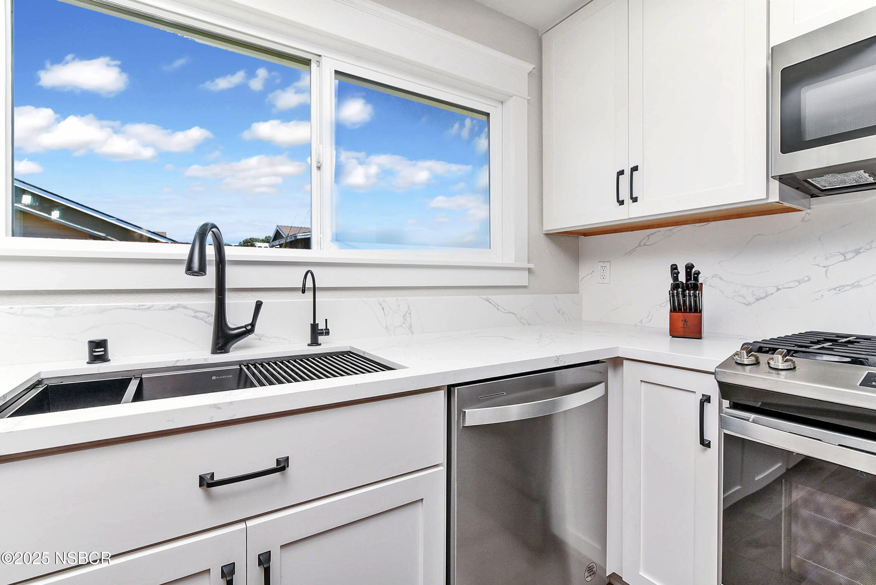 1133 Alden Avenue Lompoc, CA 93436 - Photo 12 of 27 a kitchen with a sink and a stove