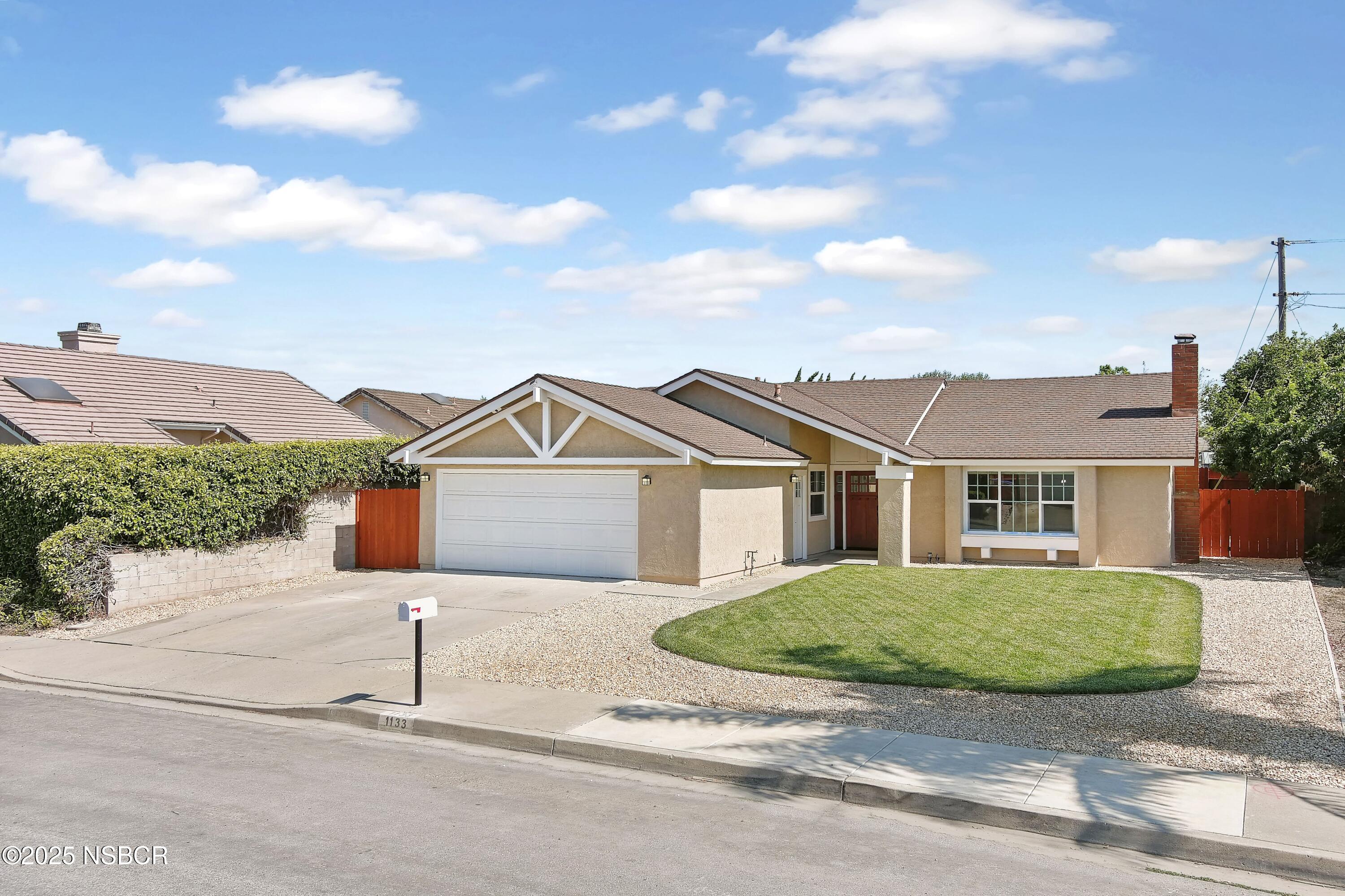 1133 Alden Avenue Lompoc, CA 93436 - Photo 2 of 27 a front view of a house with a garden and yard
