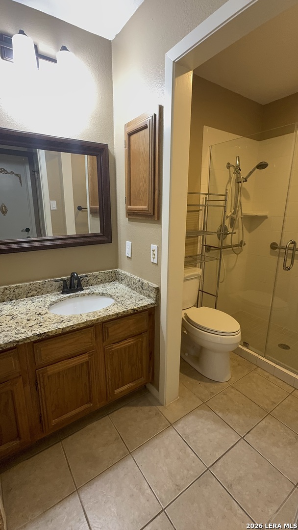 11520 Huebner Road, Unit 205 San Antonio, TX 78230 - Photo 1 of 8 a spacious bathroom with a granite countertop sink toilet and shower