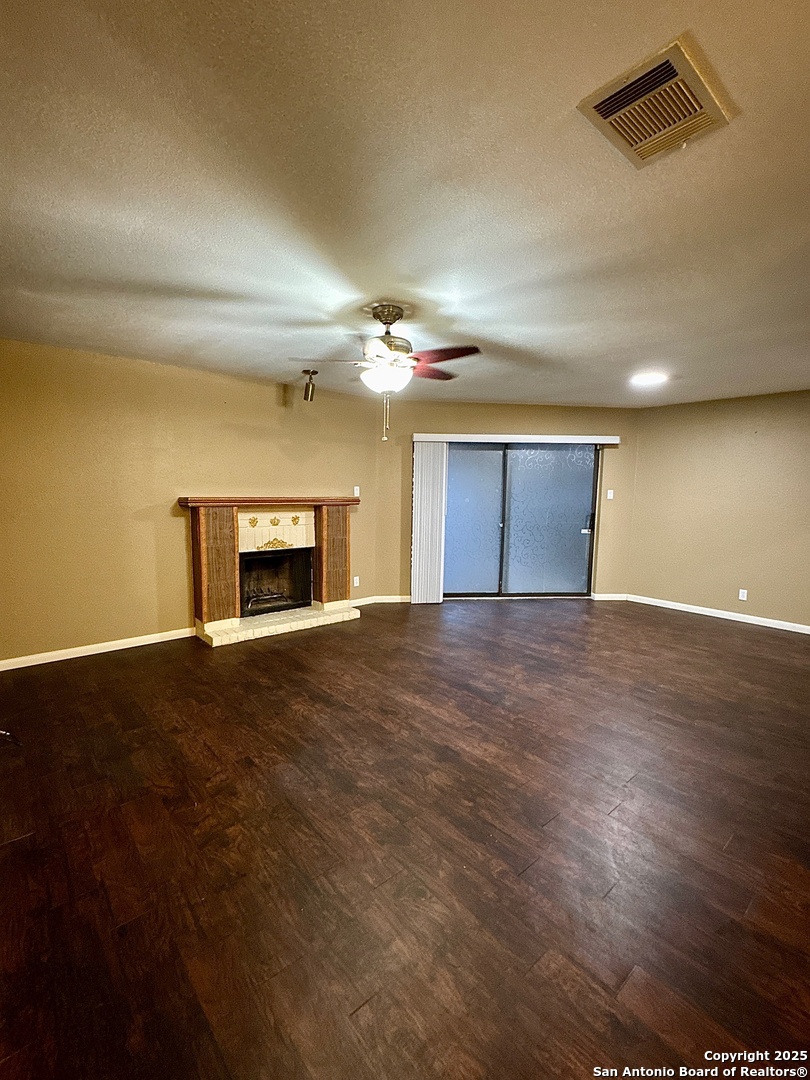 11520 Huebner Road, Unit 205 San Antonio, TX 78230 - Photo 3 of 8 a view of an empty room with a fireplace and a window