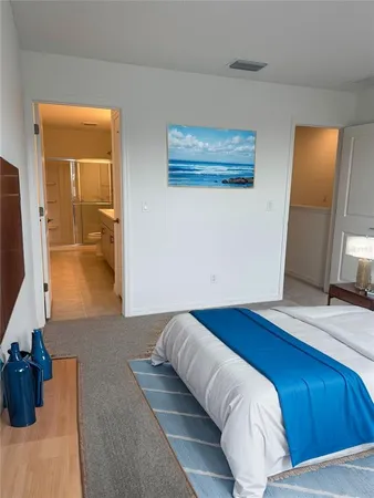 a bedroom with a bed and a mirror