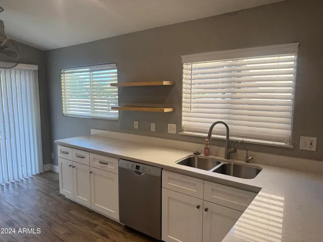 a kitchen with a sink and wooden cabinets