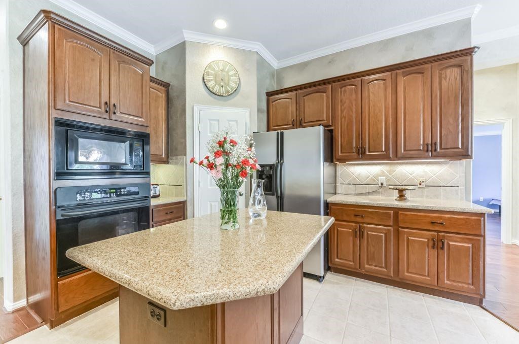31 North Warbler Bend Circle Spring, TX 77382 - Photo 8 of 31 The island kitchen is clad with gorgeous granite.