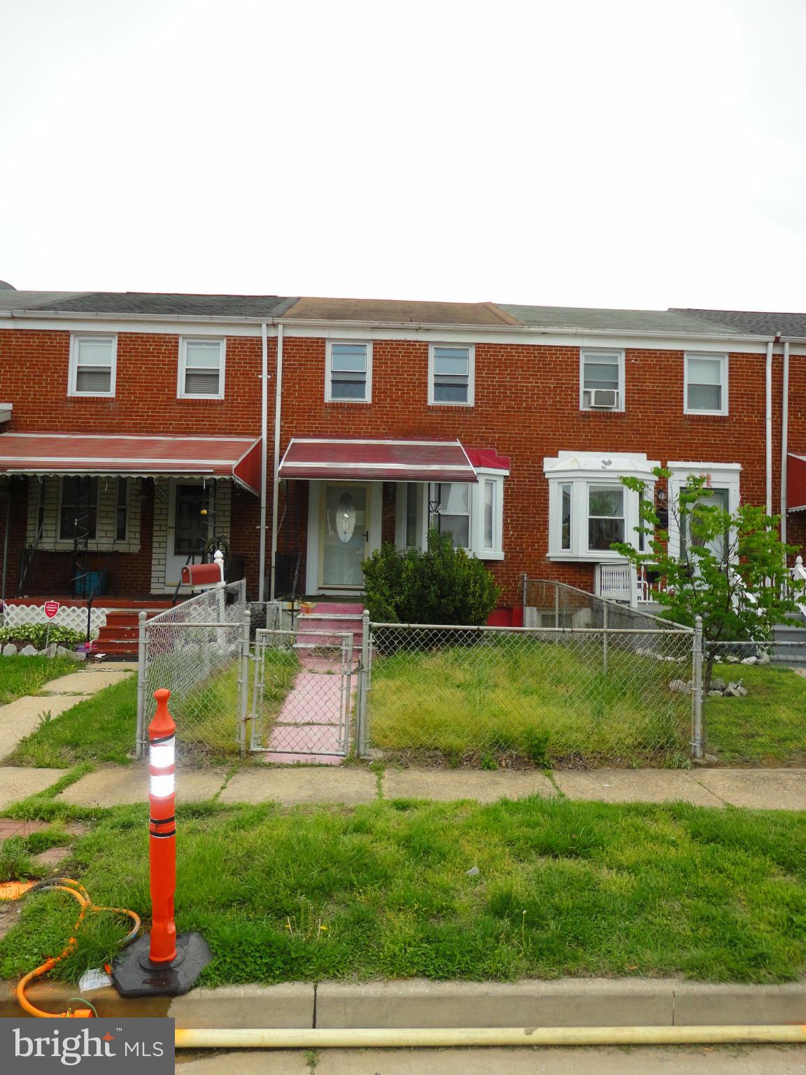 8539 Kavanagh Road Dundalk, MD 21222 - Photo 2 of 4 a front view of a house with a yard table and chairs