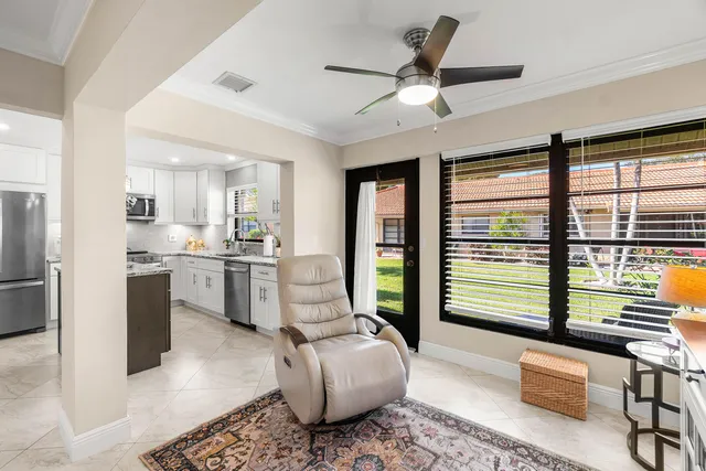a living room with furniture and large windows