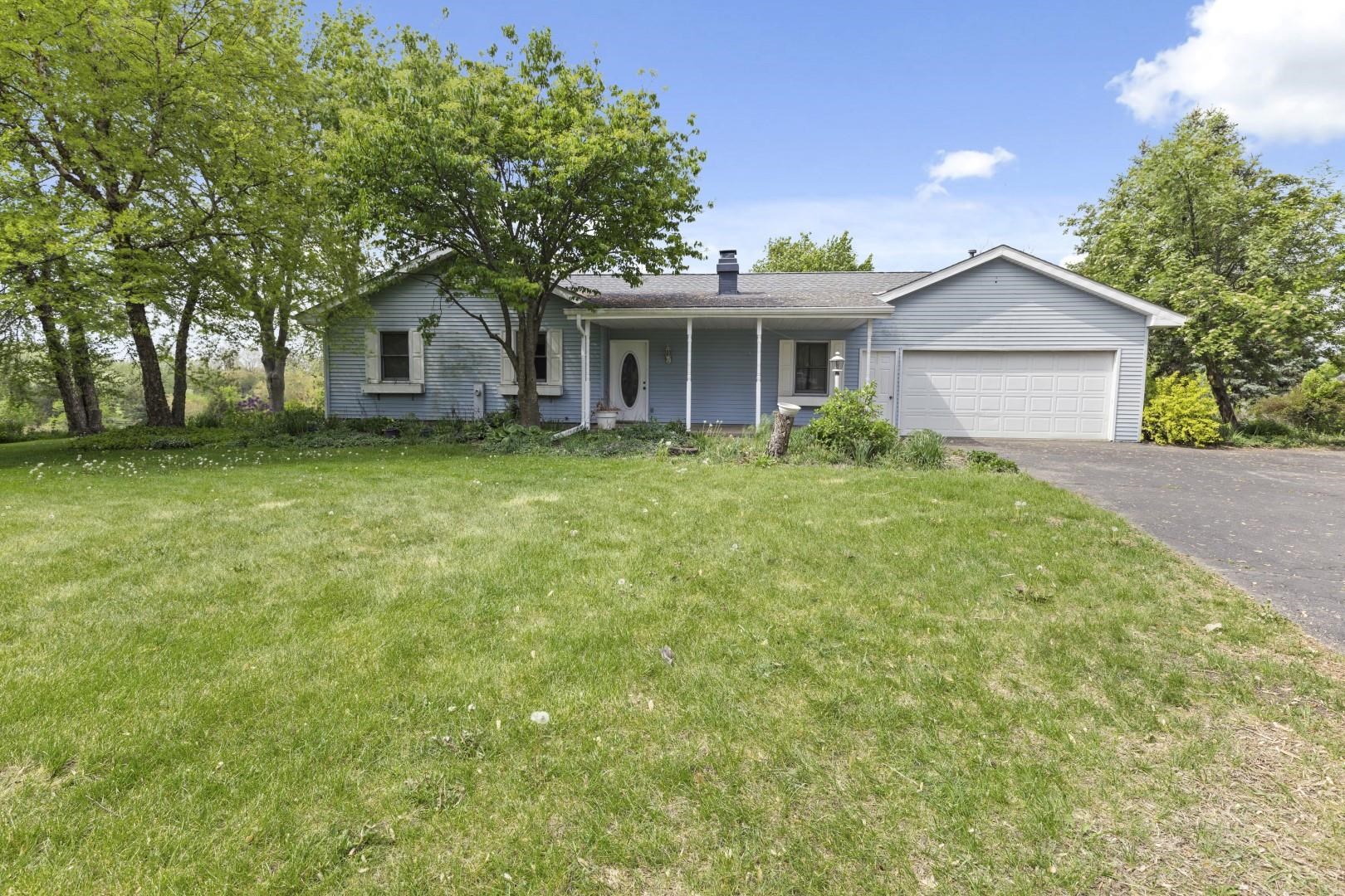 8530 North Kishwaukee Road Stillman Valley, IL 61084 - Photo 1 of 44 a front view of a house with a garden