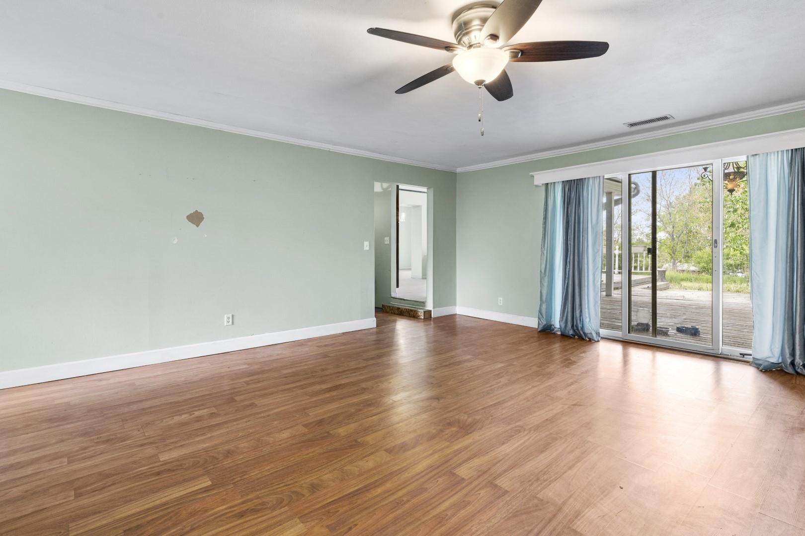 8530 North Kishwaukee Road Stillman Valley, IL 61084 - Photo 12 of 44 a view of an empty room with wooden floor and a window