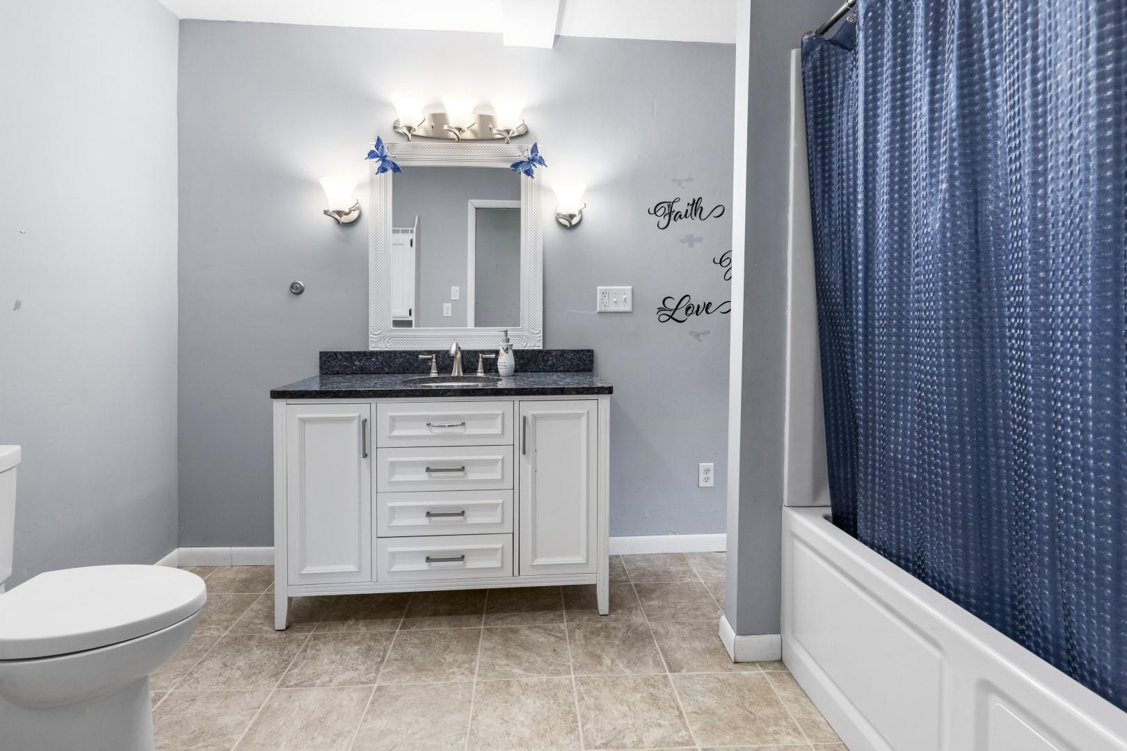 8530 North Kishwaukee Road Stillman Valley, IL 61084 - Photo 17 of 44 a bathroom with a sink a toilet and shower