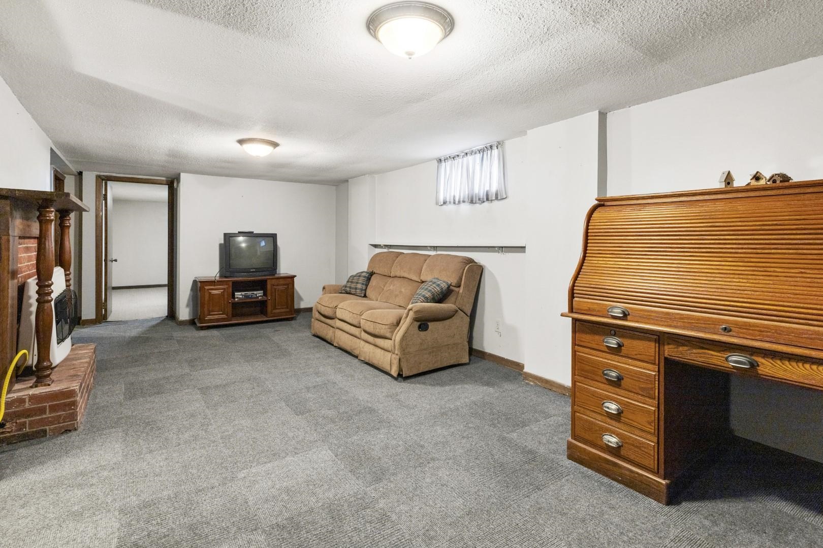 8530 North Kishwaukee Road Stillman Valley, IL 61084 - Photo 23 of 44 a living room with furniture and a flat screen tv