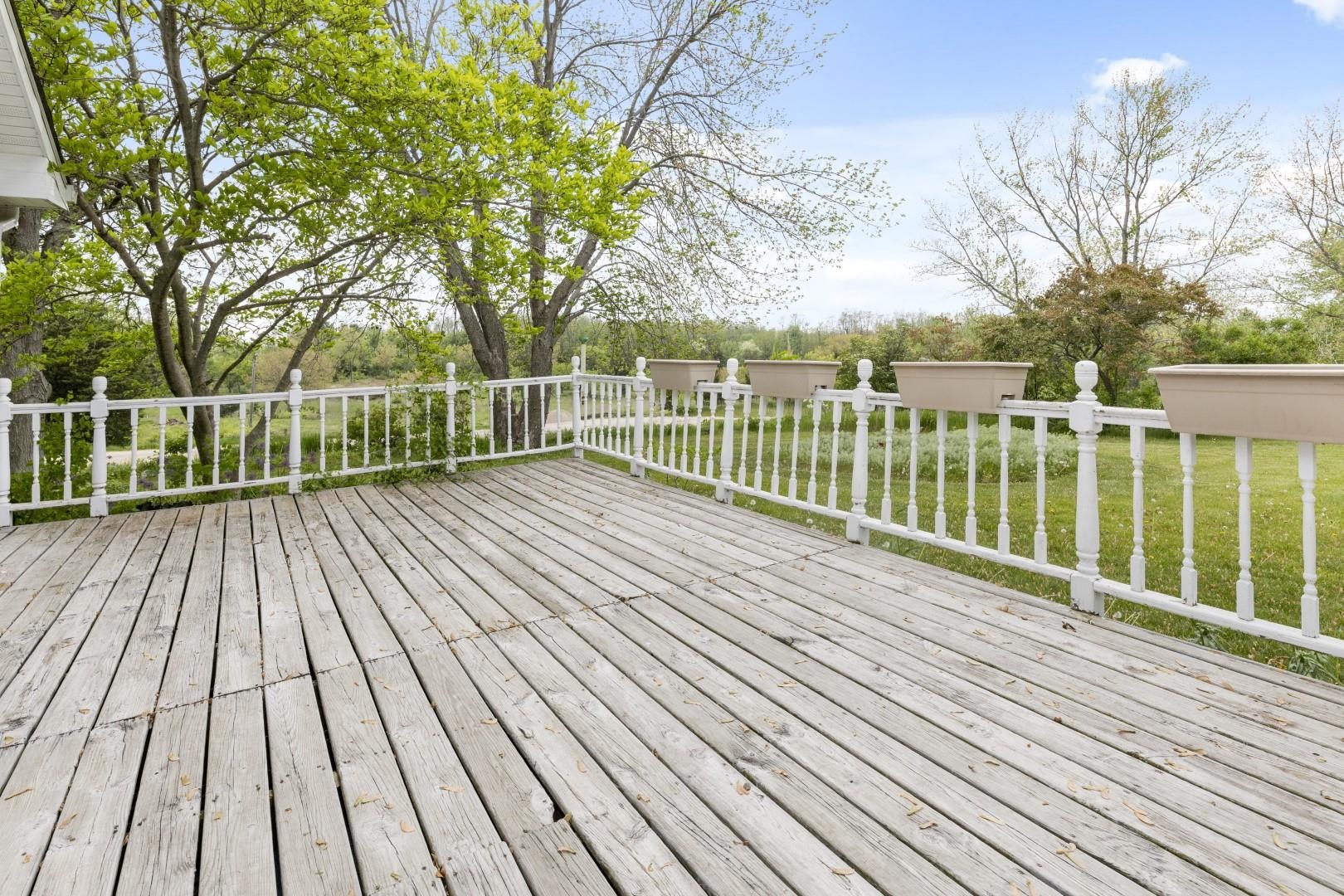 8530 North Kishwaukee Road Stillman Valley, IL 61084 - Photo 32 of 44 a view of balcony with wooden floor and fence