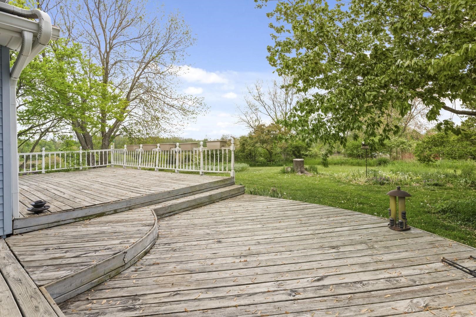 8530 North Kishwaukee Road Stillman Valley, IL 61084 - Photo 33 of 44 a view of a yard with plants and large tree