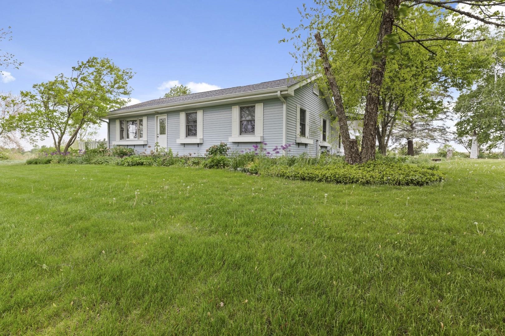 8530 North Kishwaukee Road Stillman Valley, IL 61084 - Photo 38 of 44 a front view of a house with a garden