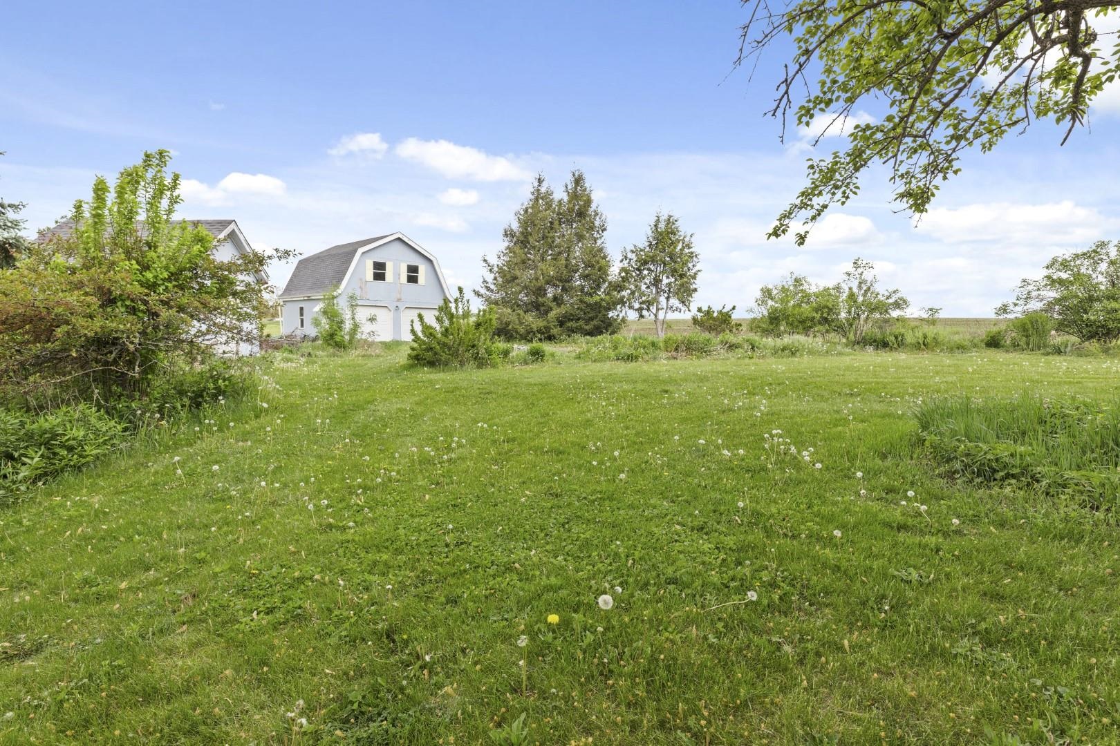 8530 North Kishwaukee Road Stillman Valley, IL 61084 - Photo 41 of 44 a view of a big yard with a house in the background