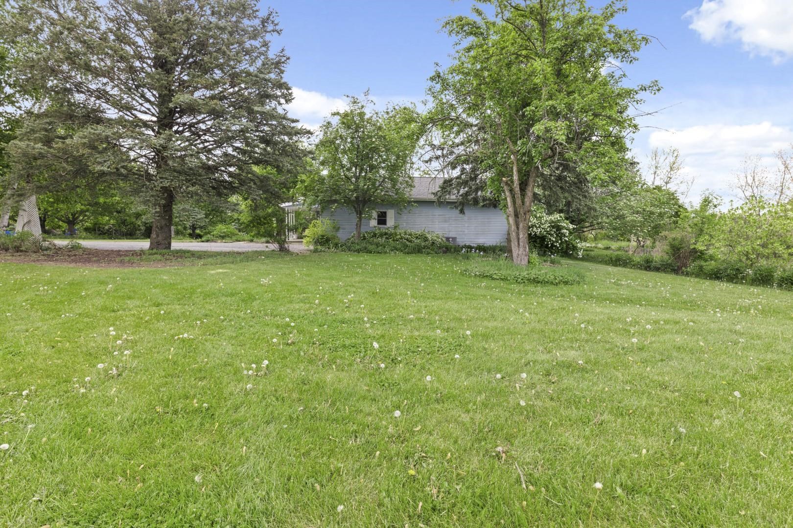 8530 North Kishwaukee Road Stillman Valley, IL 61084 - Photo 42 of 44 a view of a grassy field with trees in the background