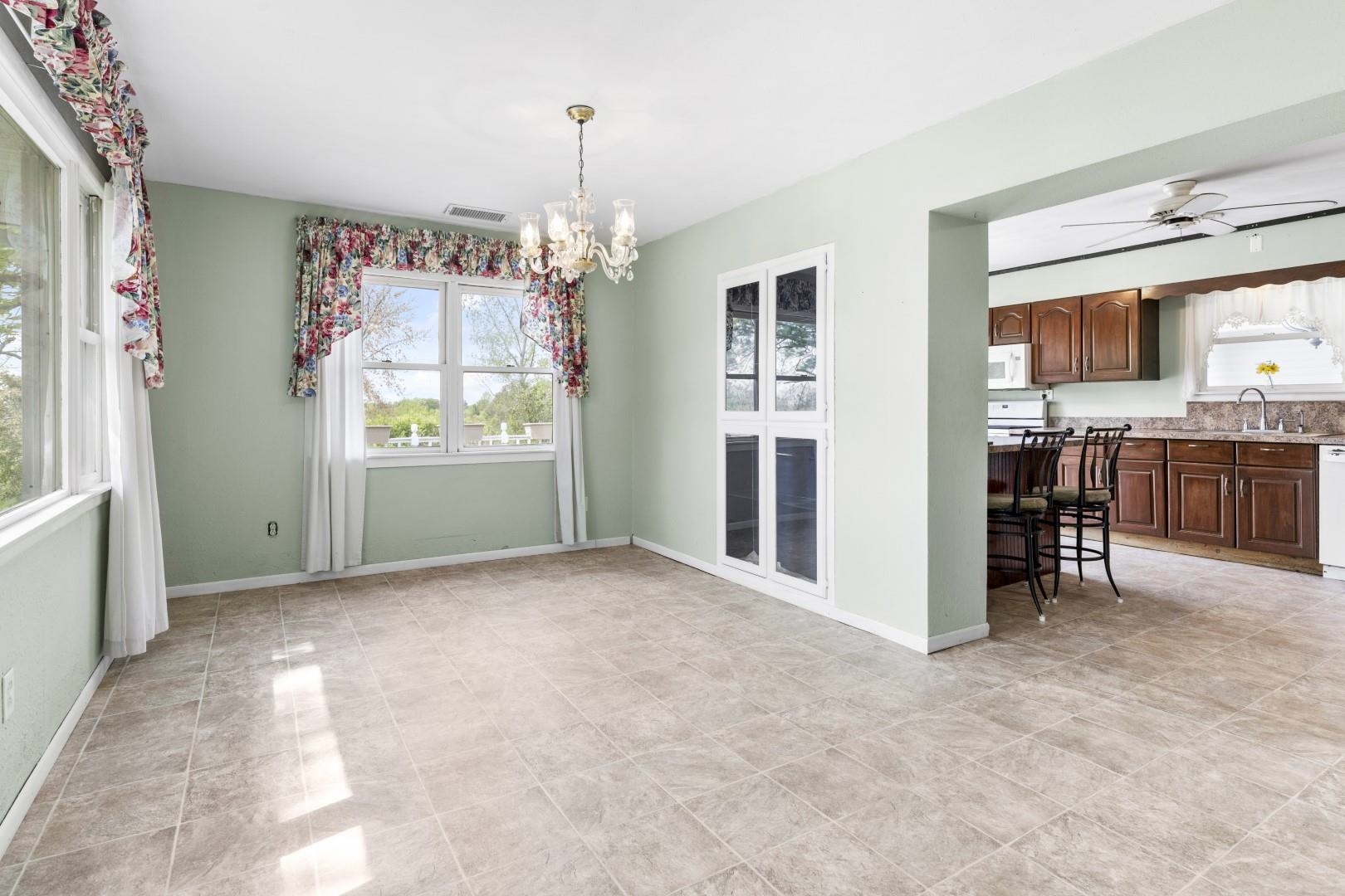 8530 North Kishwaukee Road Stillman Valley, IL 61084 - Photo 9 of 44 a view of a kitchen with furniture and a window
