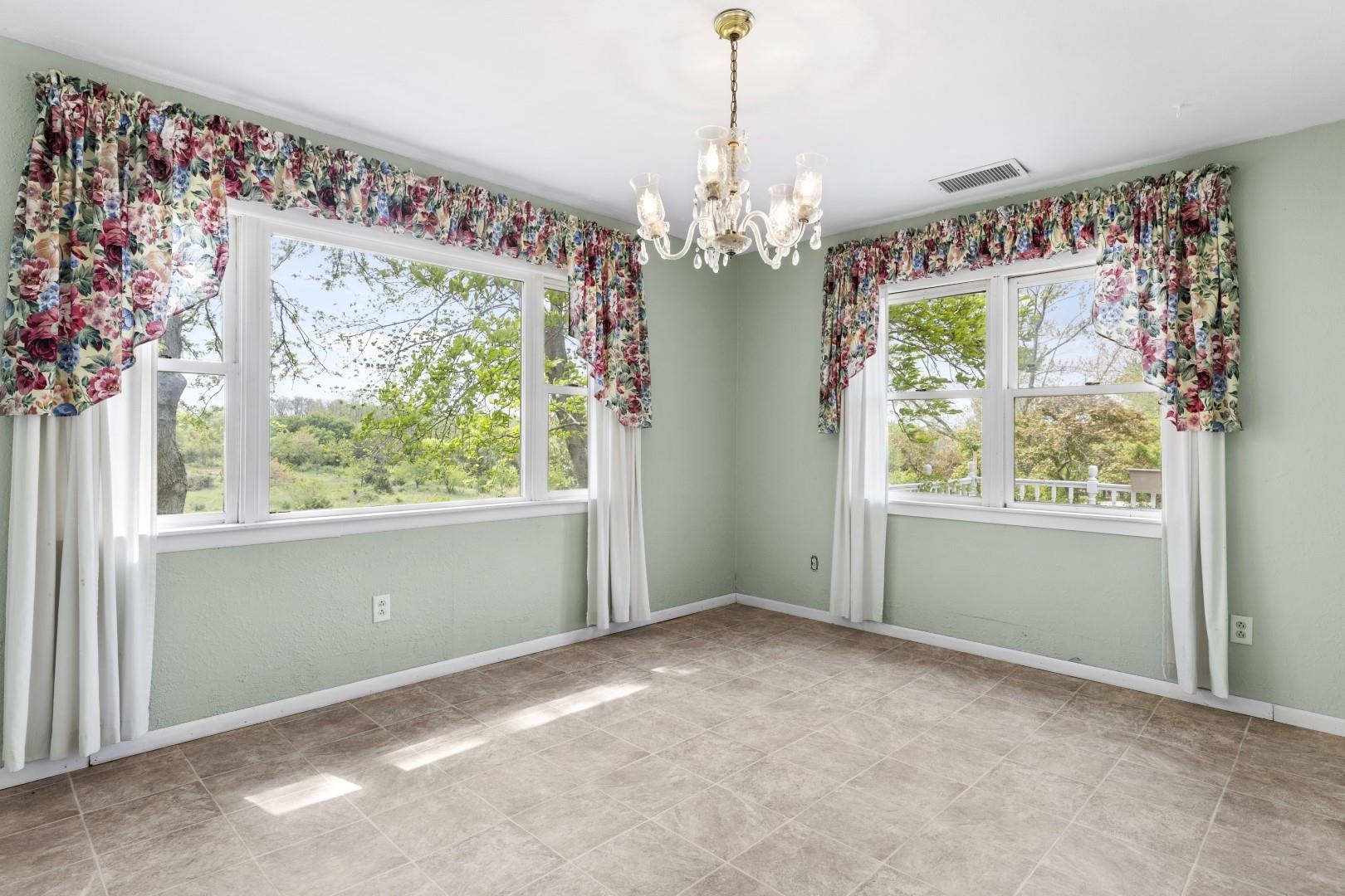 8530 North Kishwaukee Road Stillman Valley, IL 61084 - Photo 10 of 44 a view of an empty room with a window