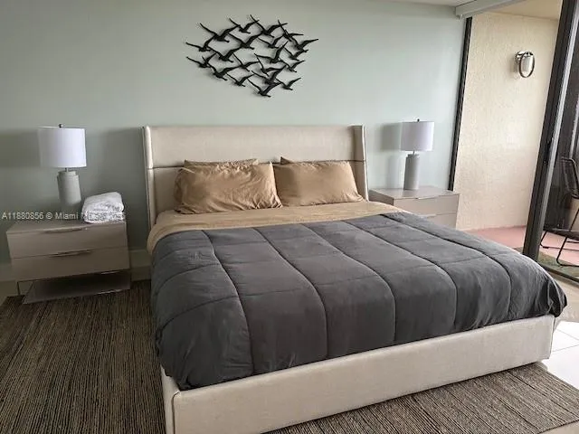 a bedroom with a bed and a night stand