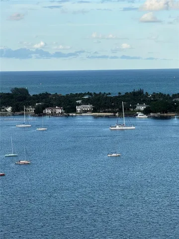a bathroom with a granite countertop sink a toilet a mirror and shower