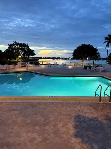 a bedroom with a bed lamp and a fireplace