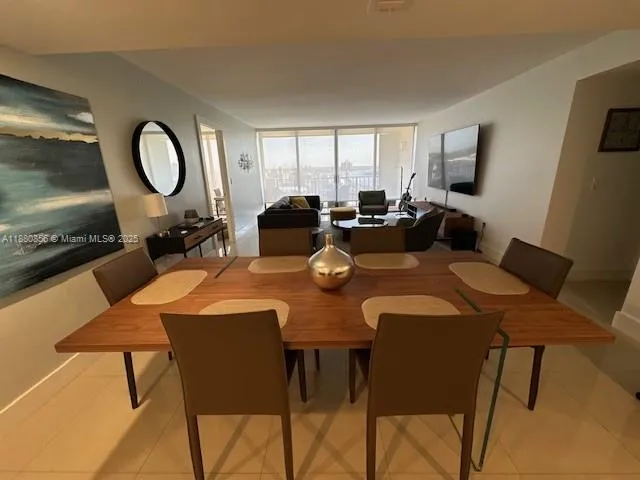 a living room with furniture kitchen view and a dining table