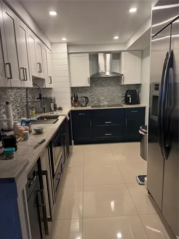 a large white kitchen with a large window