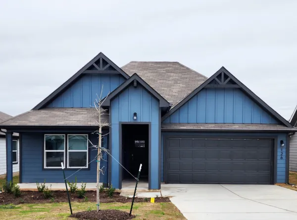 a front view of a house with garage