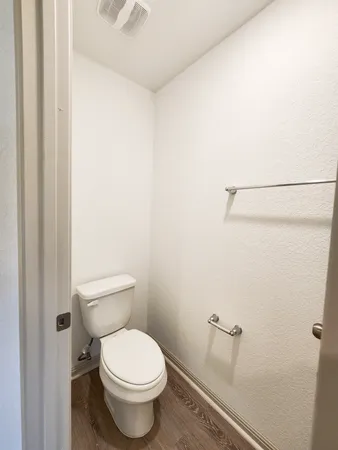 a white toilet sitting next to a shower