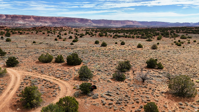358 South Sky Drive Torrey, UT 84775 - Photo 51 of 82 Expansive arid landscape featuring scattered desert shrubs and visible red dirt tracks