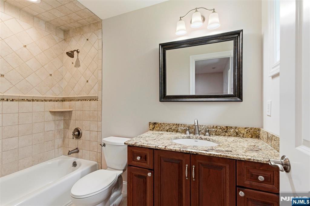 767 Orangeburgh Road River Vale, NJ 07675 - Photo 30 of 49 a bathroom with a granite countertop toilet a sink and bathtub