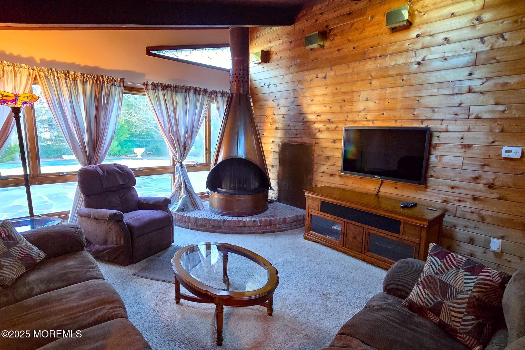 72 Pershing Boulevard Lavallette, NJ 08735 - Photo 13 of 48 a living room with furniture a window and a flat screen tv