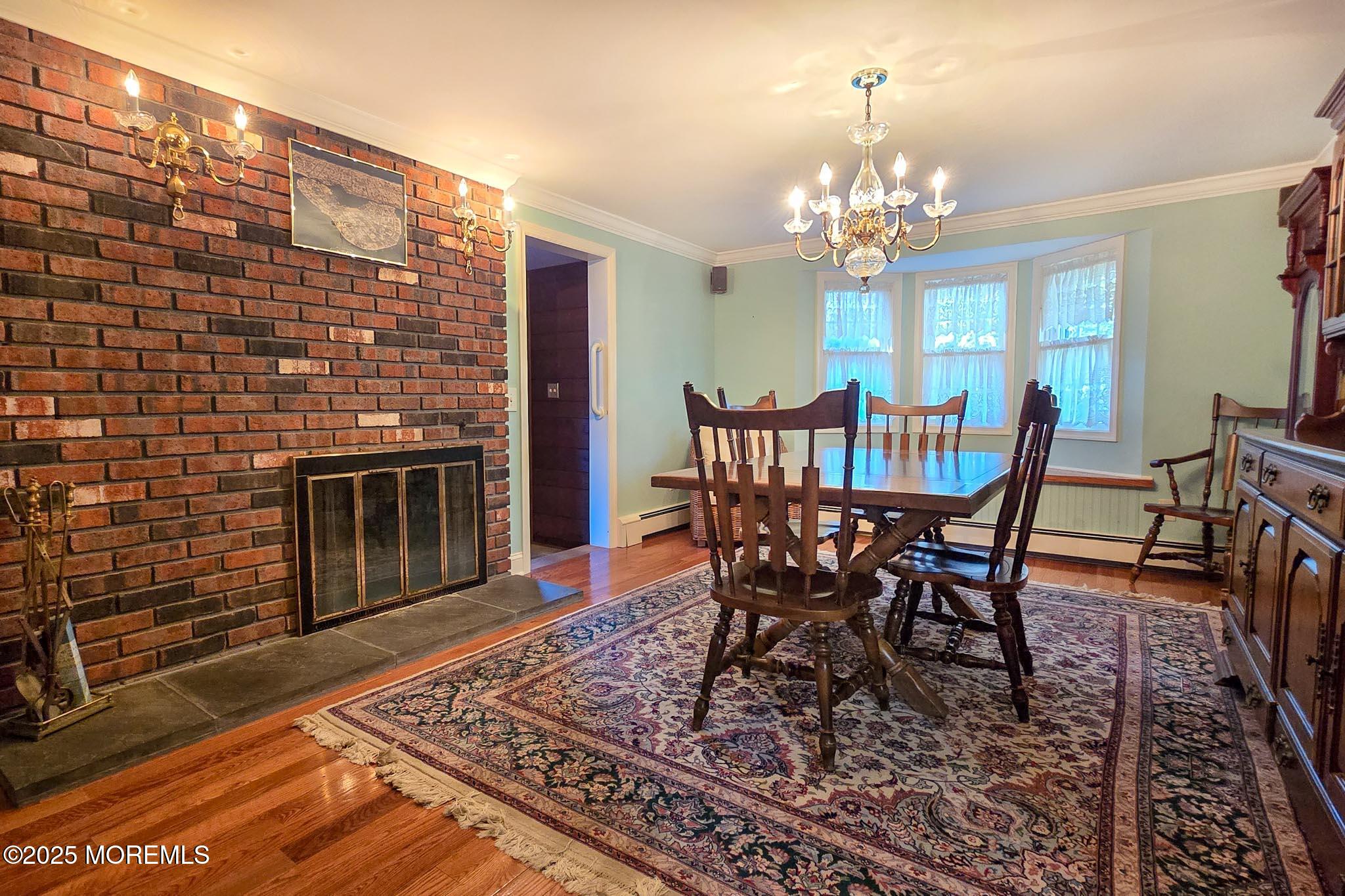 72 Pershing Boulevard Lavallette, NJ 08735 - Photo 20 of 48 a view of a dining room with furniture a chandelier and wooden floor