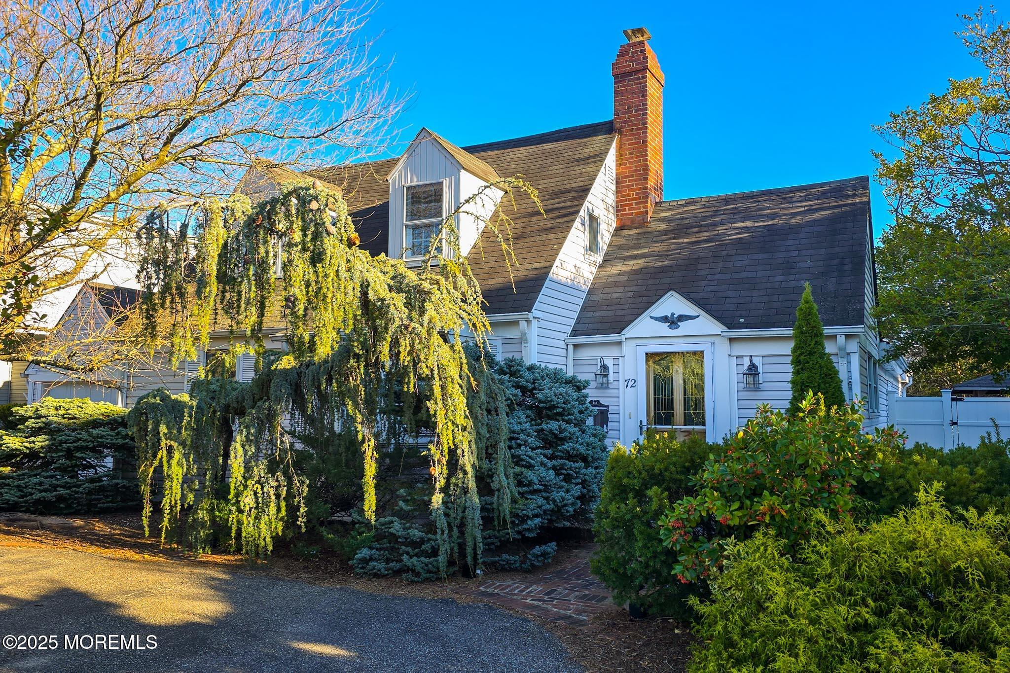 72 Pershing Boulevard Lavallette, NJ 08735 - Photo 2 of 48 a view of a brick house with a yard and plants