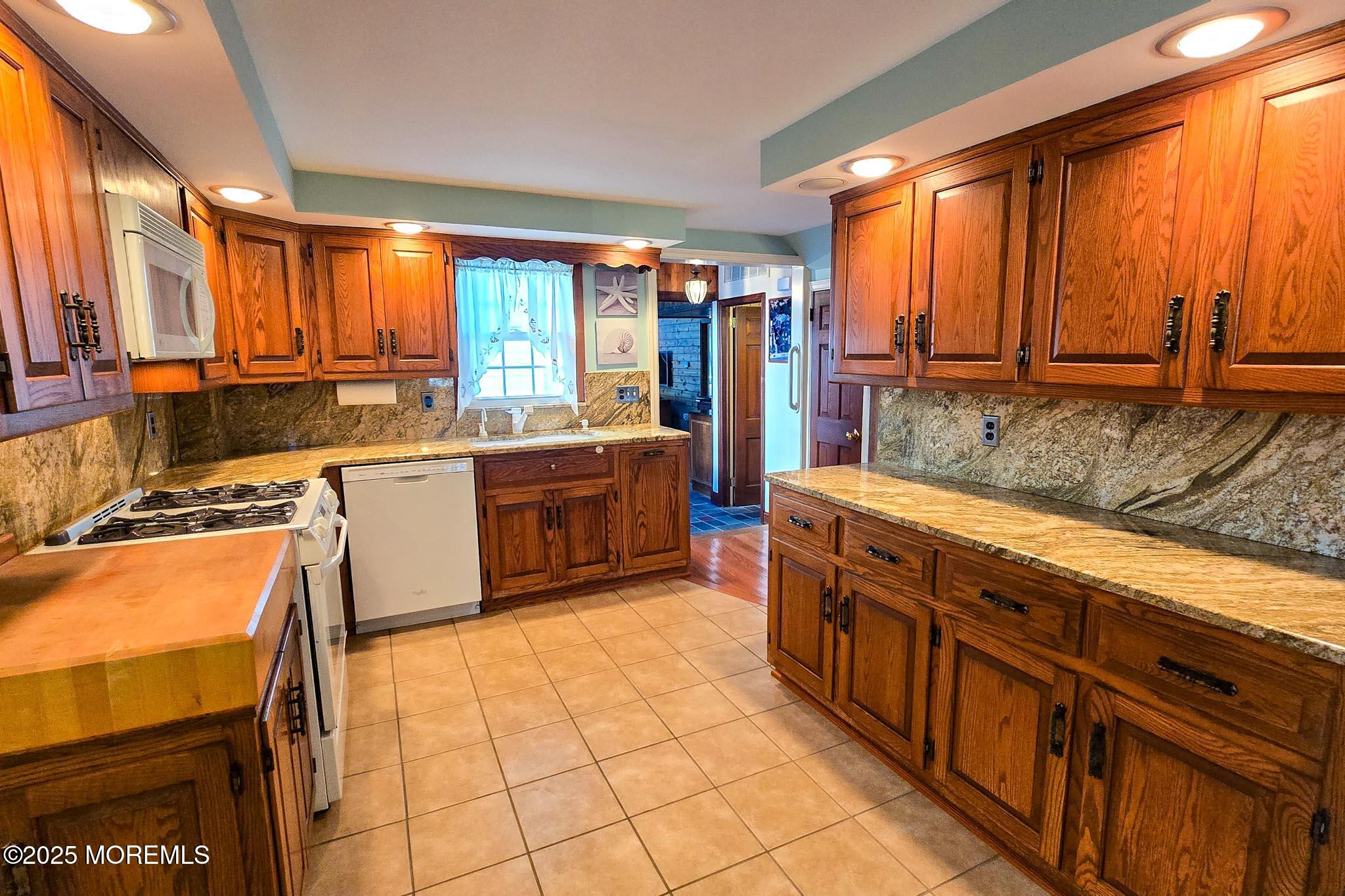 72 Pershing Boulevard Lavallette, NJ 08735 - Photo 24 of 48 a large kitchen with stainless steel appliances a sink and cabinets