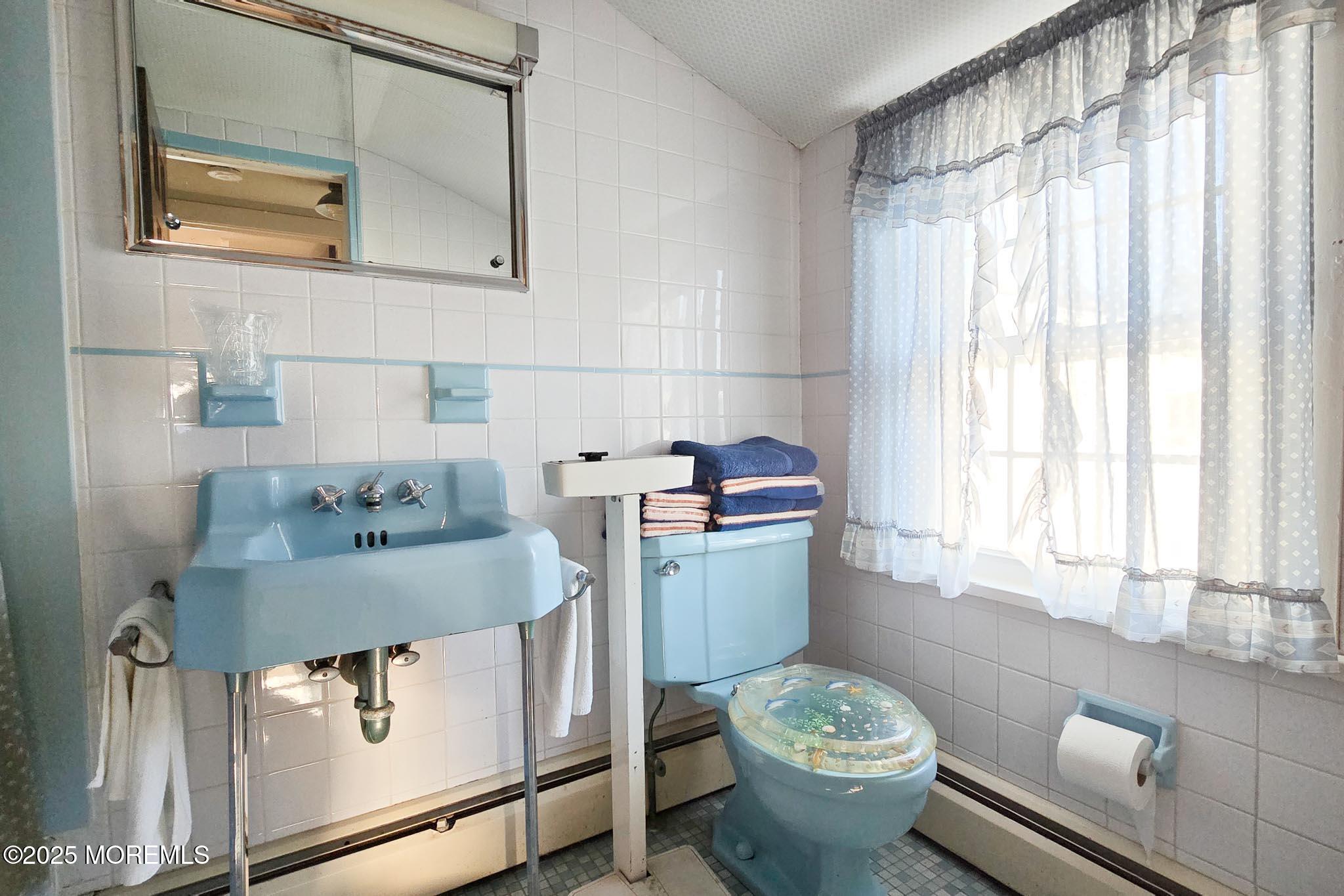 72 Pershing Boulevard Lavallette, NJ 08735 - Photo 30 of 48 a bathroom with a granite countertop toilet a sink and a window