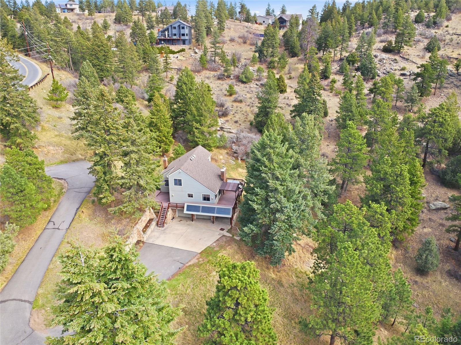an aerial view of a house with a yard basket ball court and outdoor seating