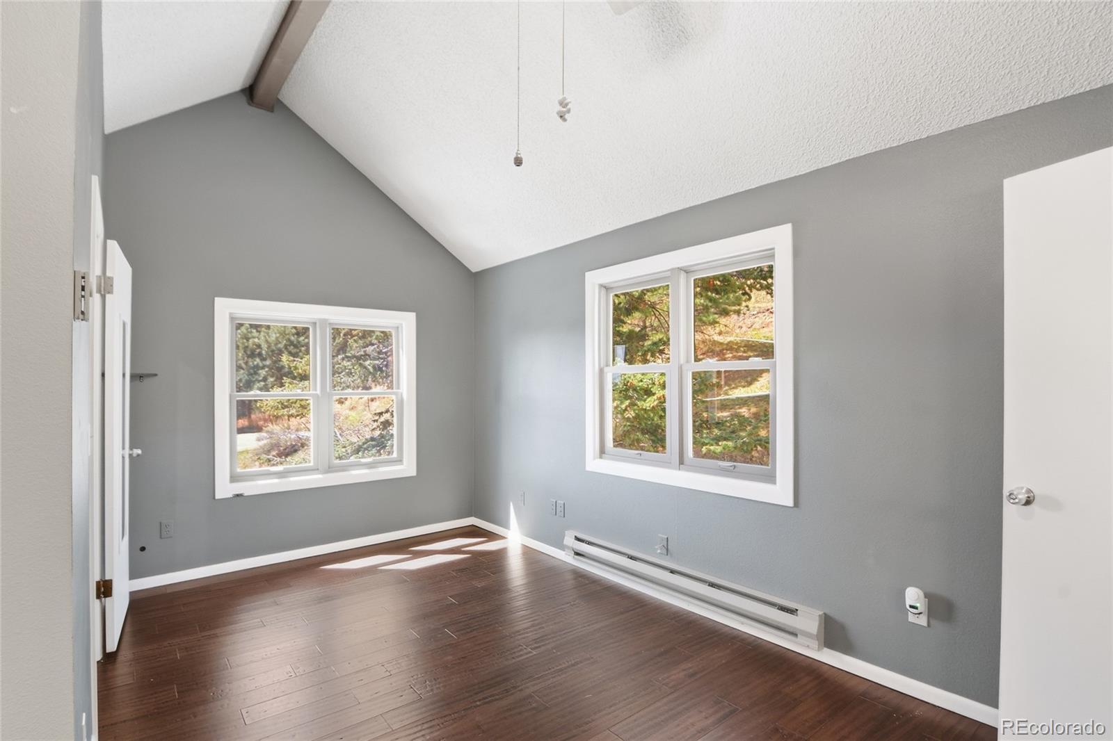 6136 High Drive Morrison, CO 80465 - Photo 11 of 40 a view of an empty room with wooden floor and a window