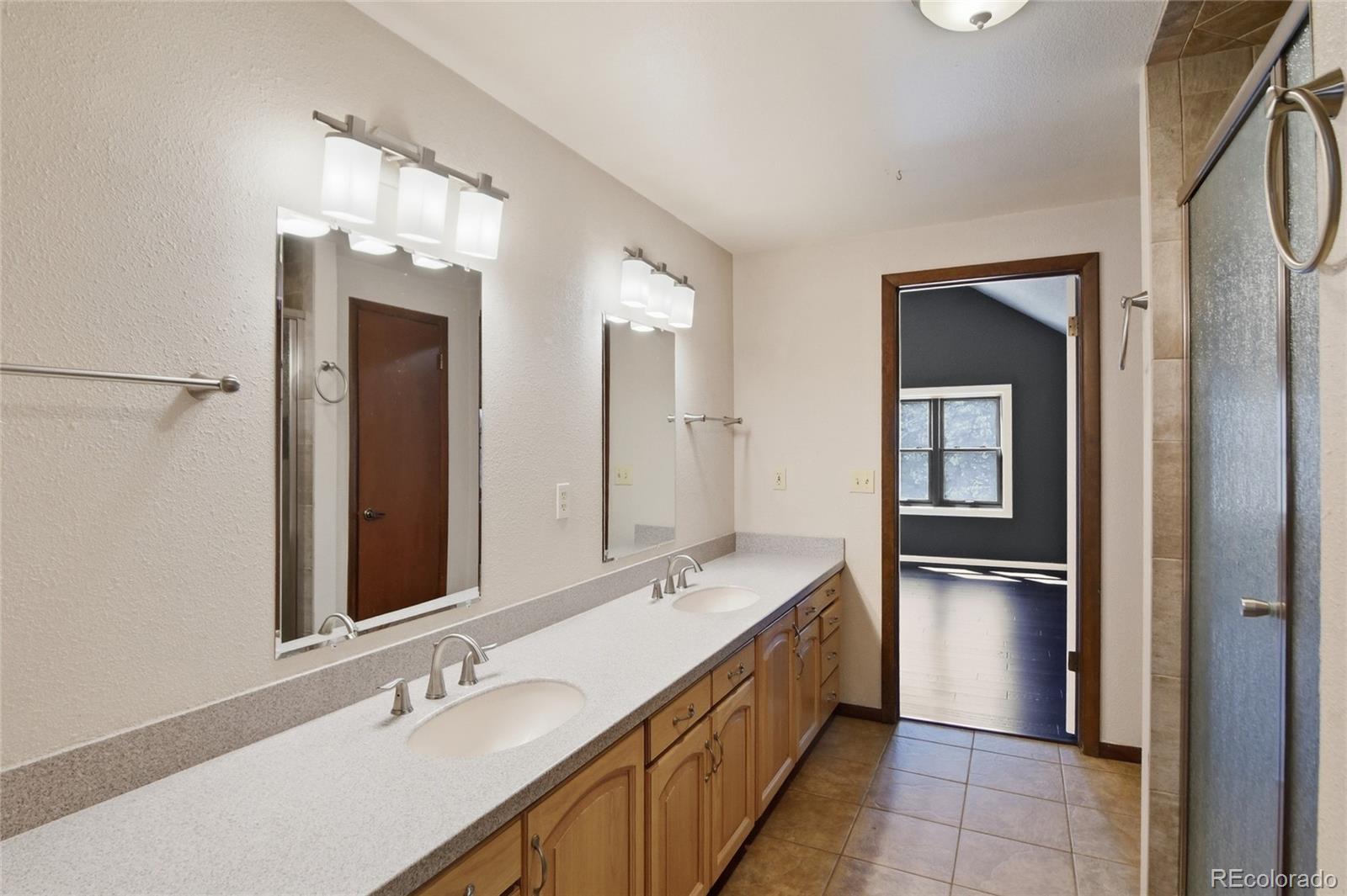 6136 High Drive Morrison, CO 80465 - Photo 14 of 40 a bathroom with a double vanity sink and a mirror