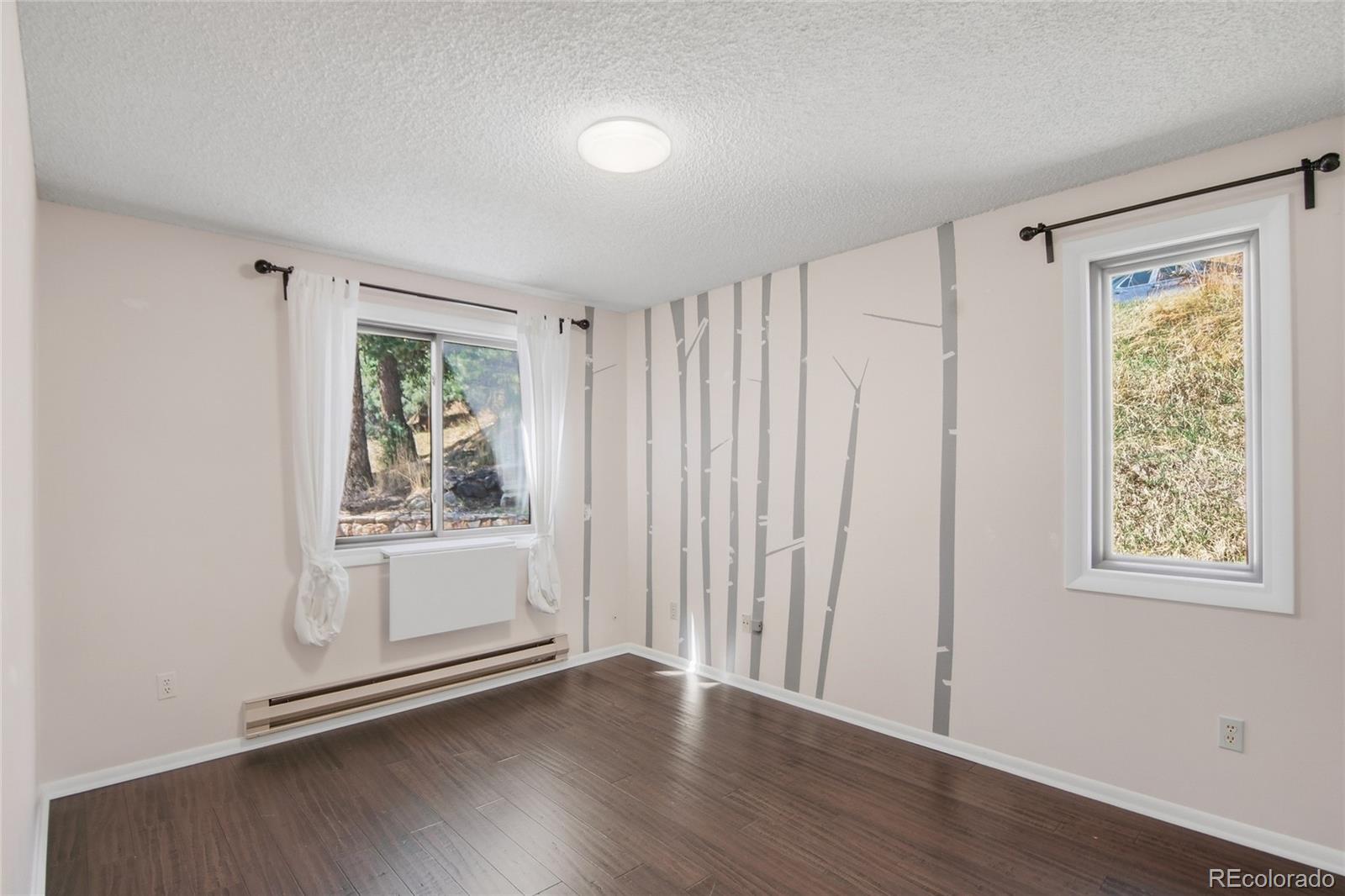 6136 High Drive Morrison, CO 80465 - Photo 23 of 40 wooden floor in an empty room with a window