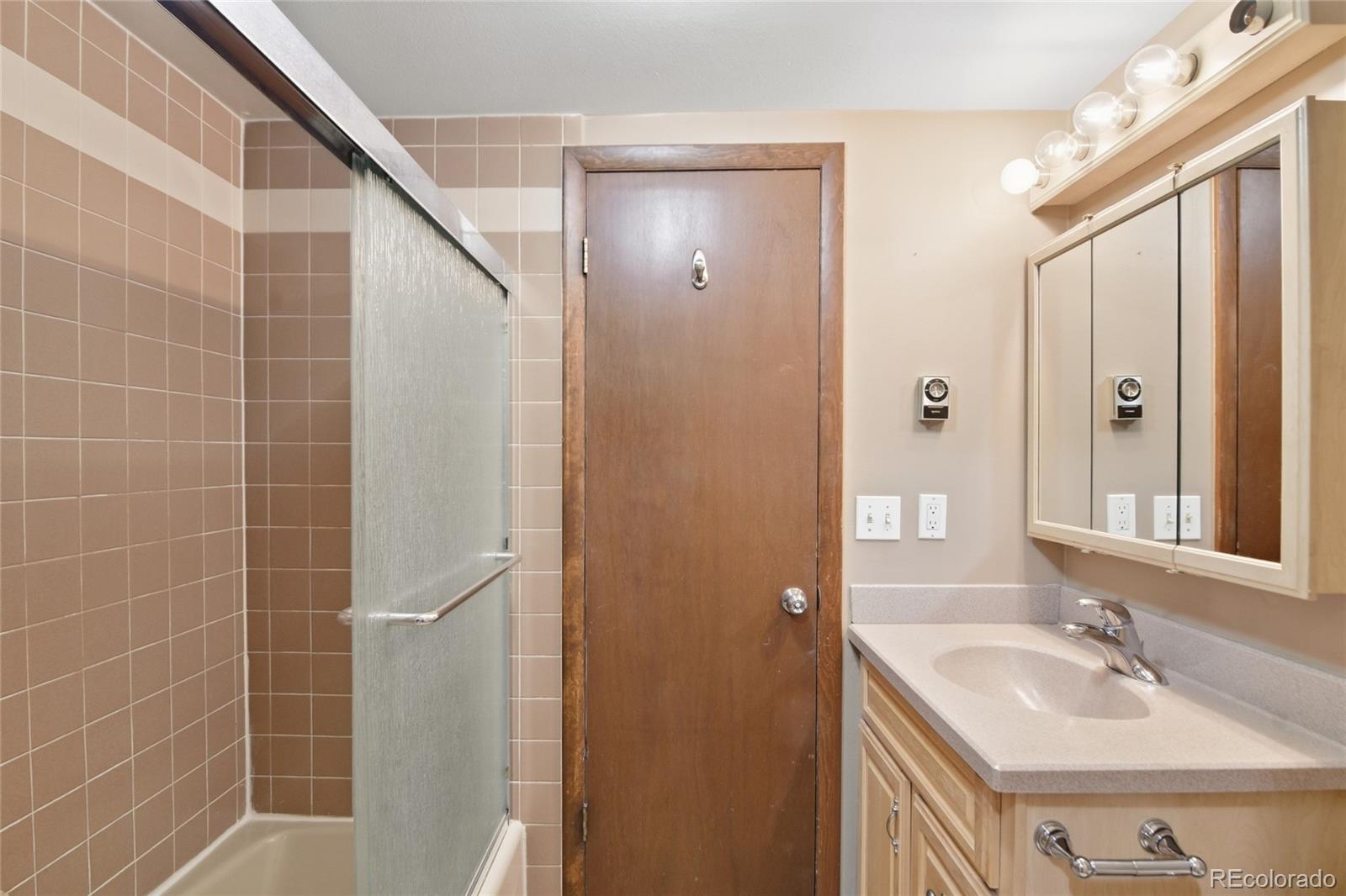 6136 High Drive Morrison, CO 80465 - Photo 25 of 40 a bathroom with a sink and a mirror