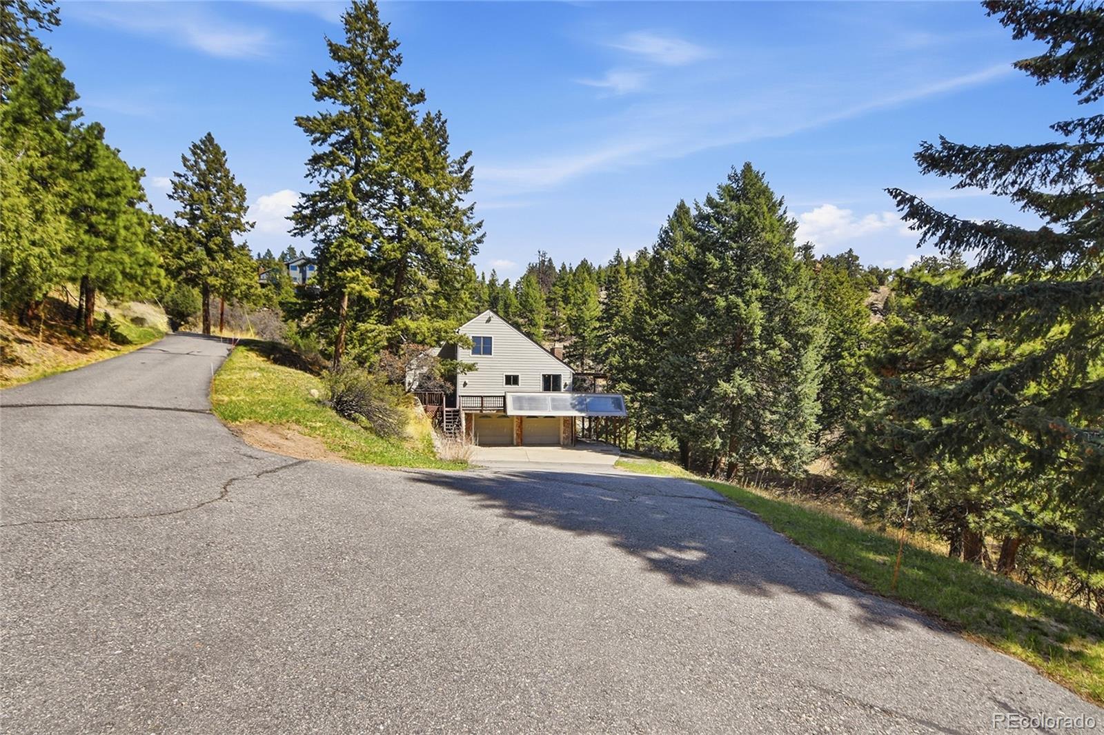 6136 High Drive Morrison, CO 80465 - Photo 31 of 40 a house with trees in the background