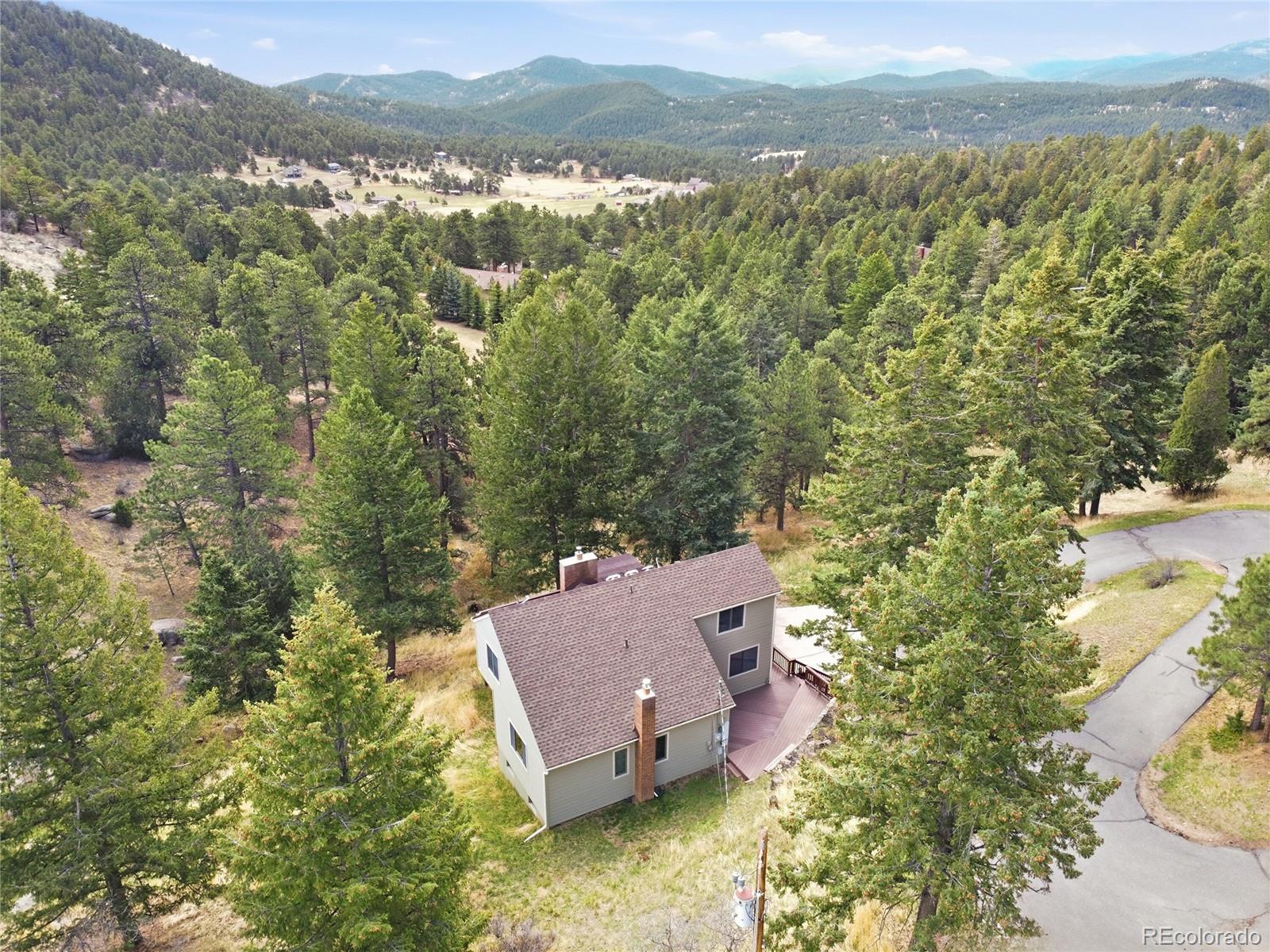 6136 High Drive Morrison, CO 80465 - Photo 36 of 40 aerial view of a house with a mountain