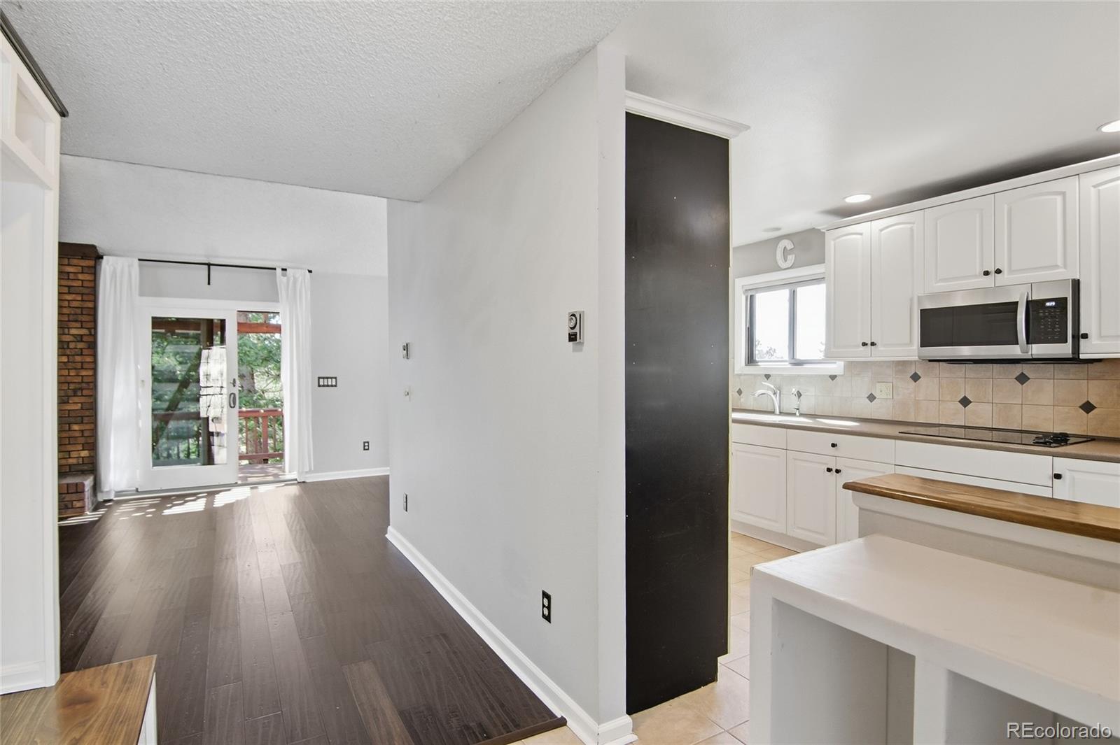 6136 High Drive Morrison, CO 80465 - Photo 4 of 40 a kitchen with a refrigerator stove and microwave