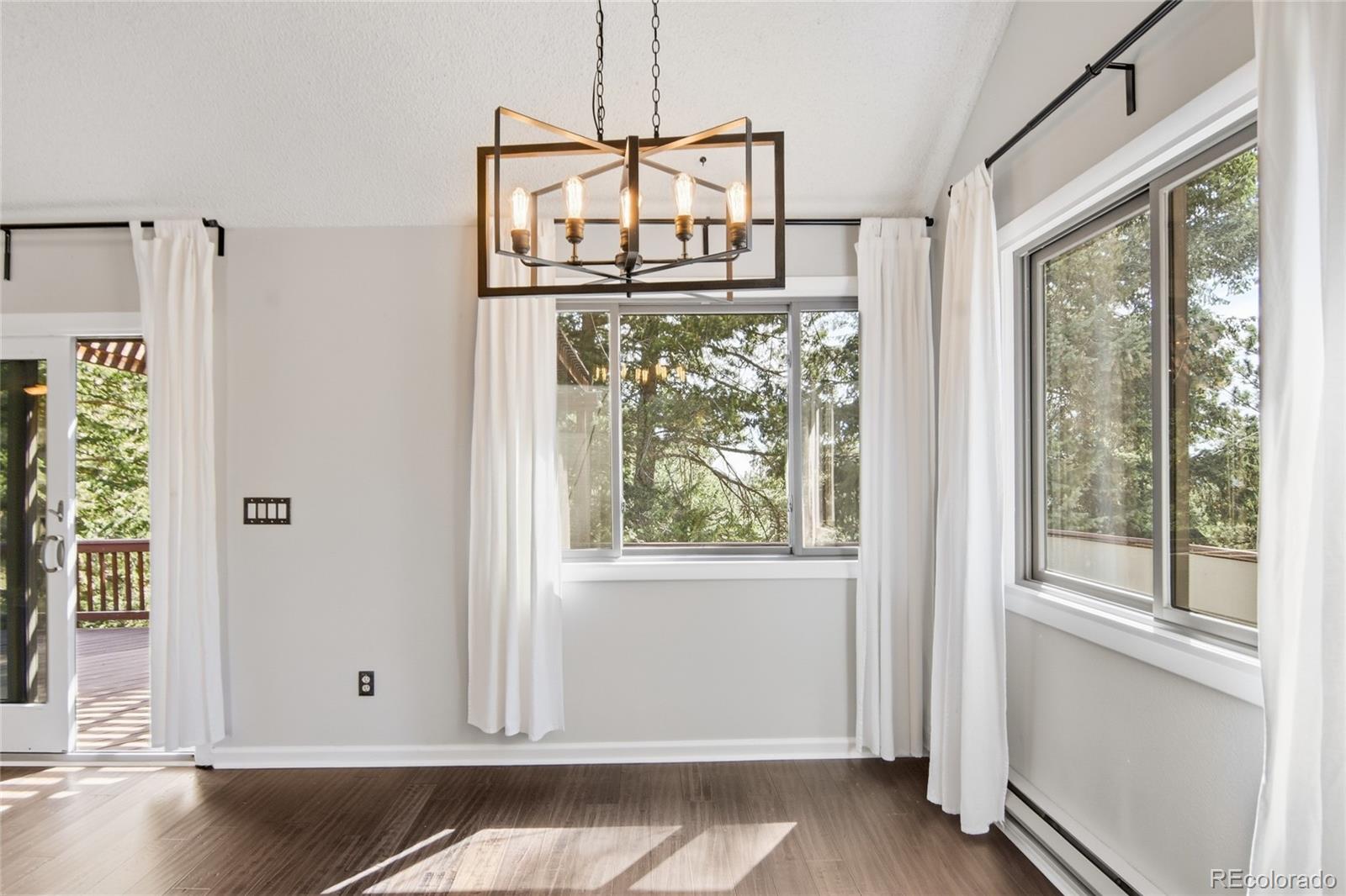 6136 High Drive Morrison, CO 80465 - Photo 7 of 40 a view of a door with wooden floor and windows